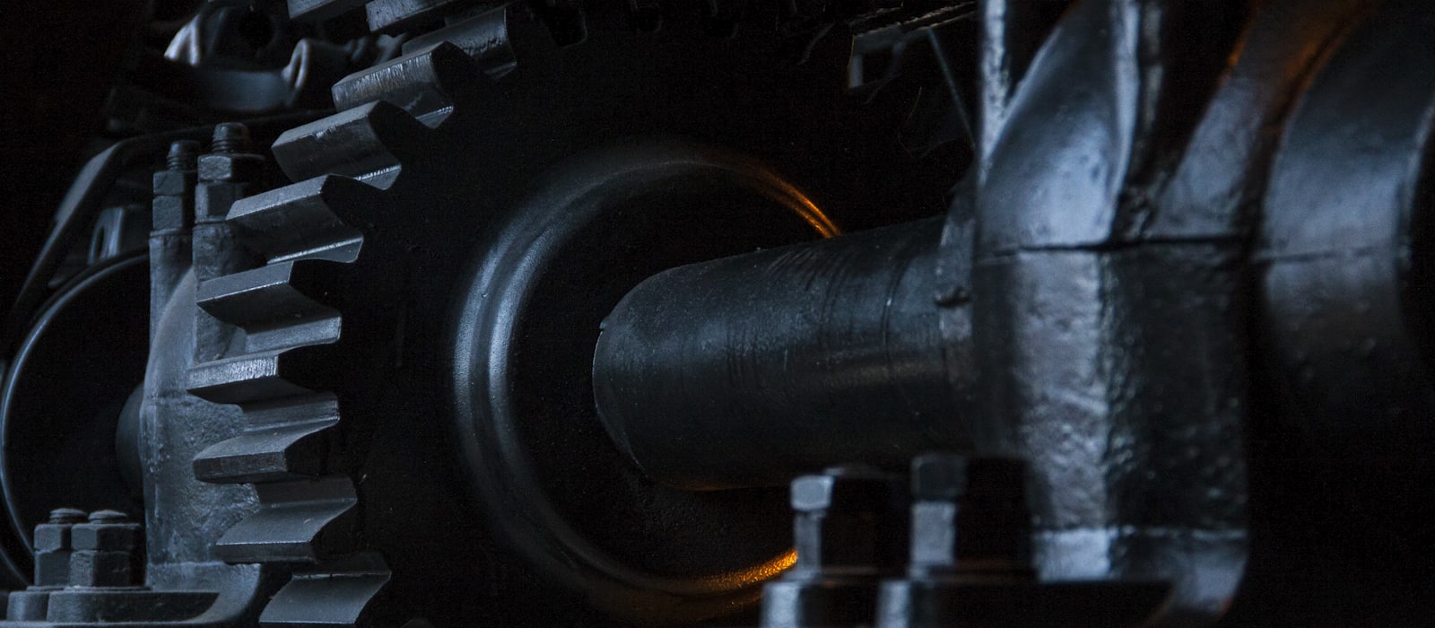 A close-up of interlocking industrial gears and a drive shaft.